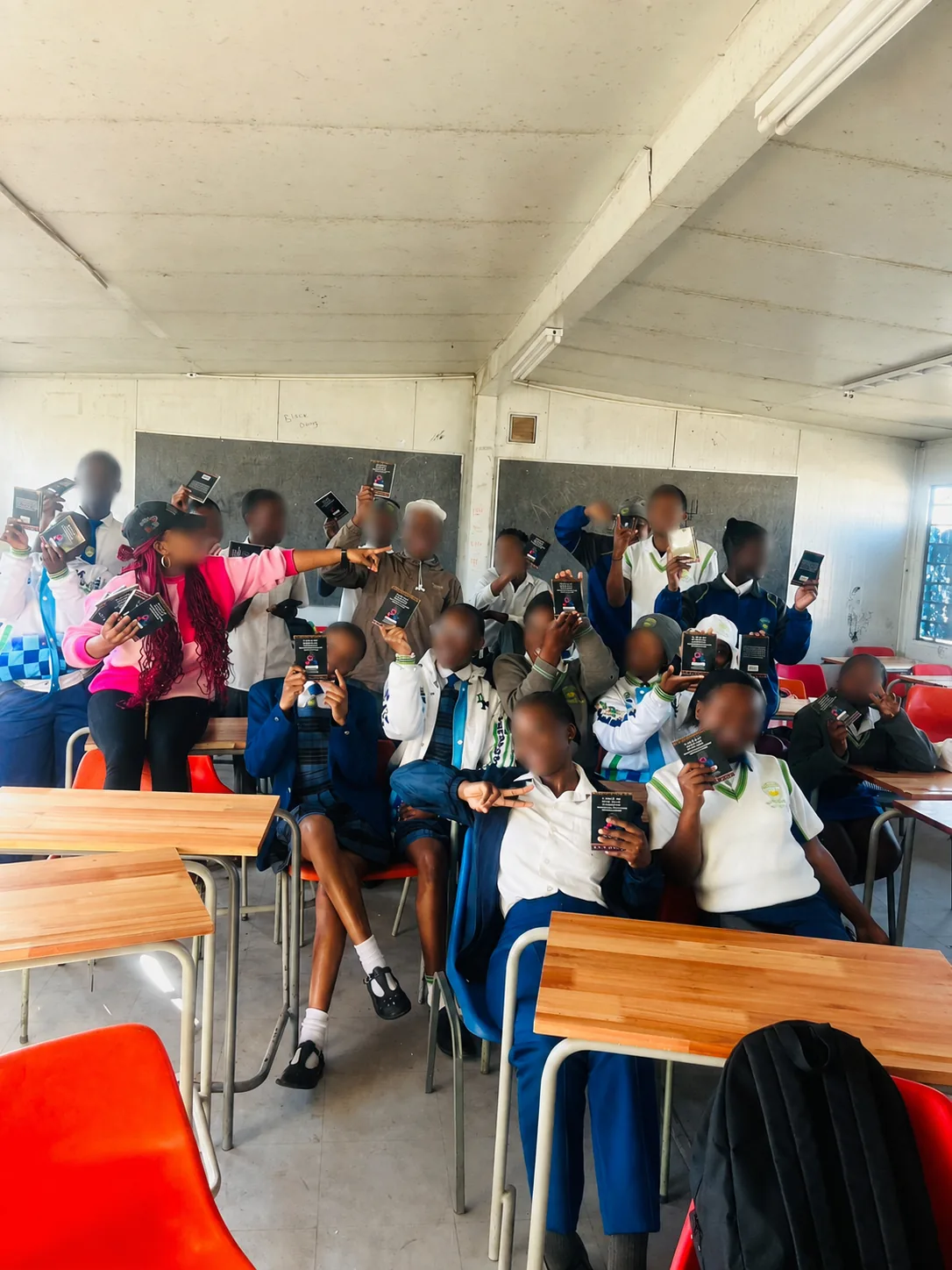 Bulk Educational Booklet Printing for School Distribution – Case Study Educational outreach booklet handover with faces blurred for privacy