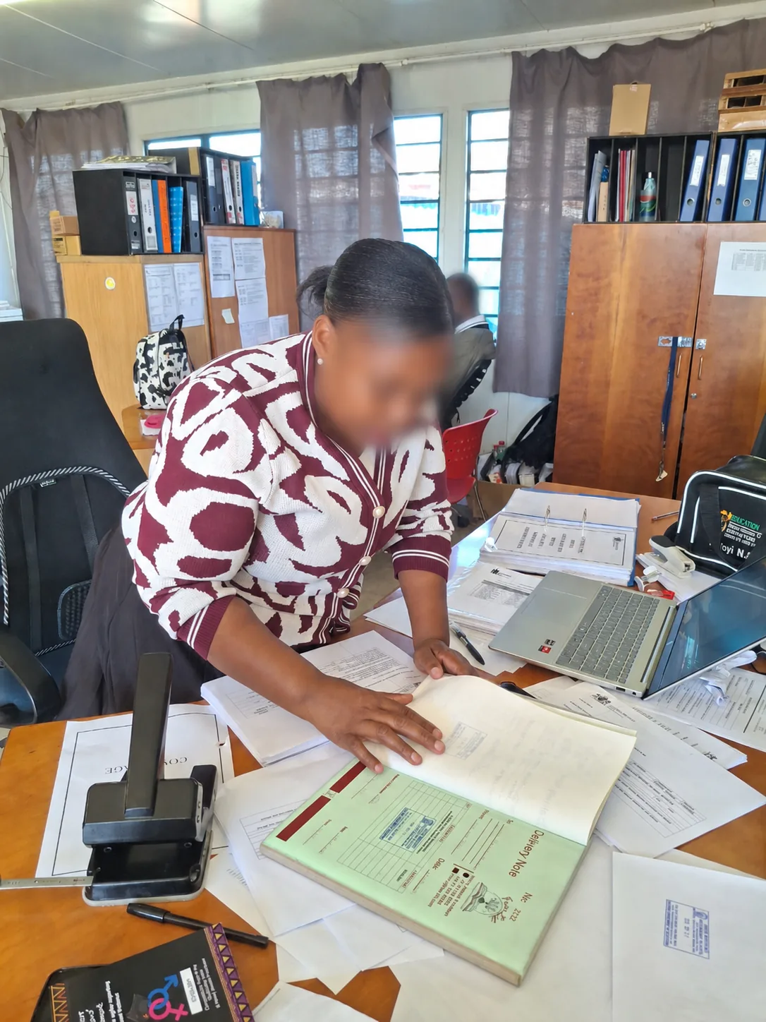 Bulk Educational Booklet Printing for School Distribution – Case Study School staff reviewing printed educational booklets with faces blurred for privacy