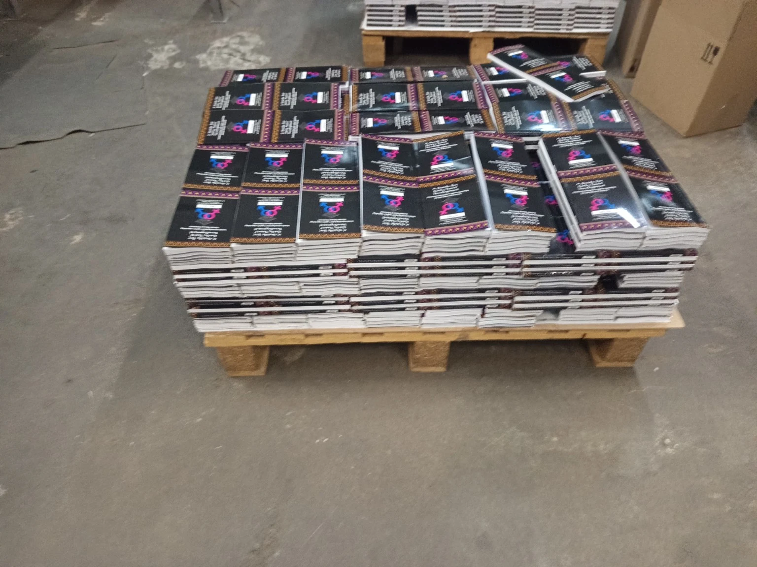 High-volume educational booklet printing stacked on pallet at Print Norwood