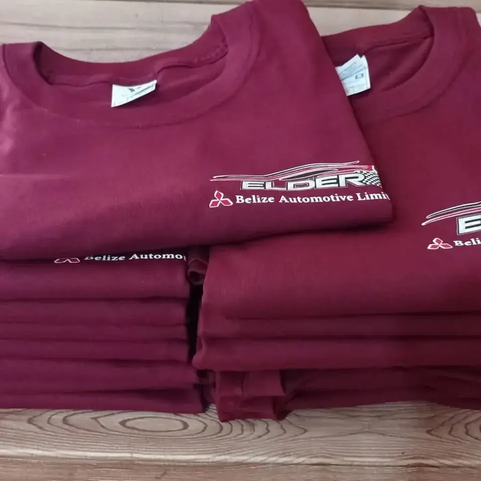 Stack of maroon shirts with embroidered corporate logo