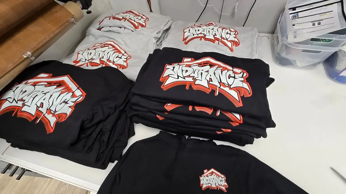 Stacks of finished screen printed shirts after bulk production