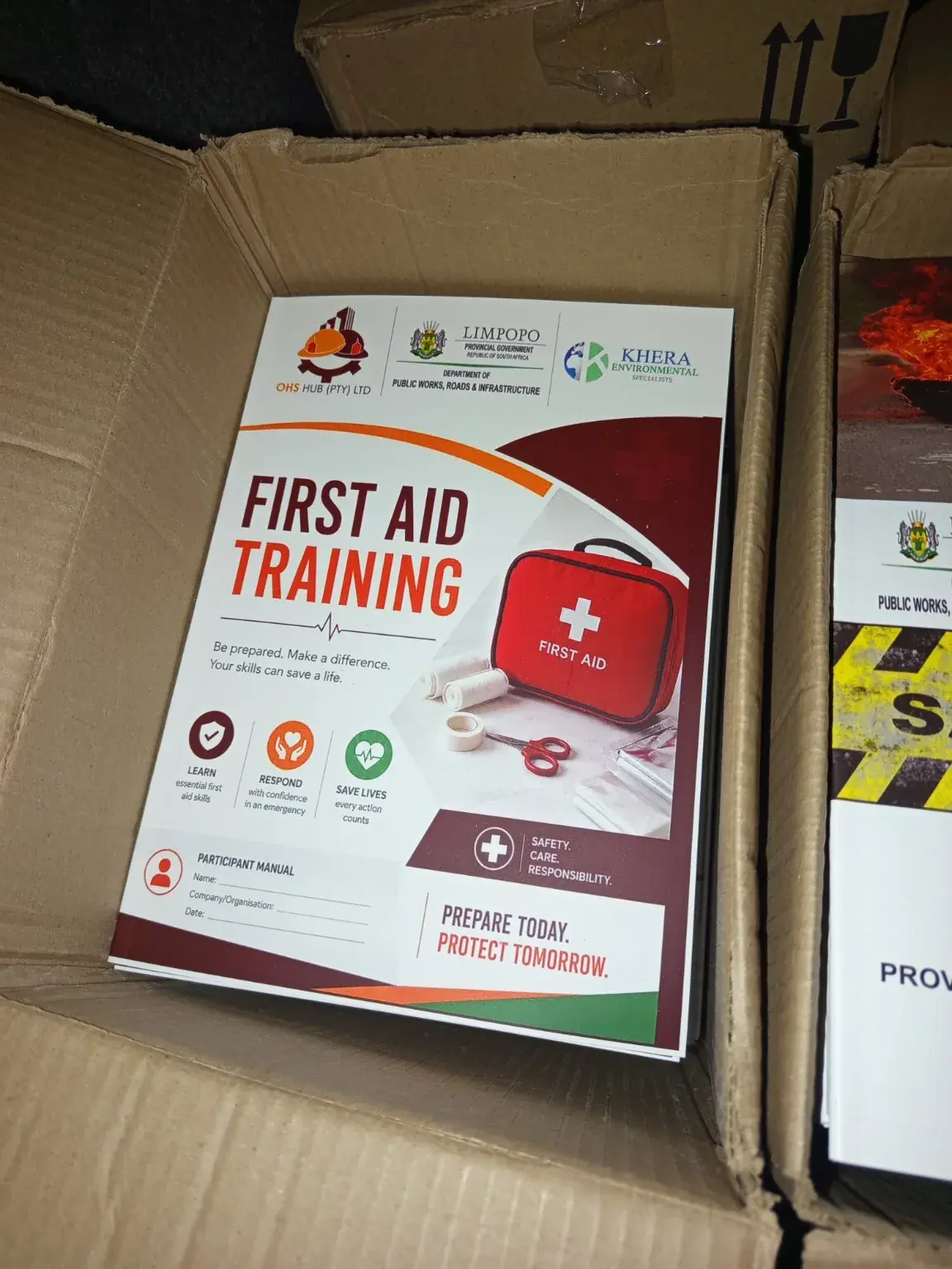 Finished first aid training manuals packed in a carton