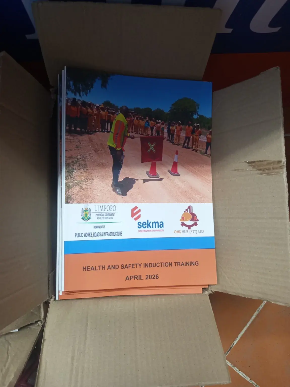 Health and safety induction training manuals packed in a delivery carton