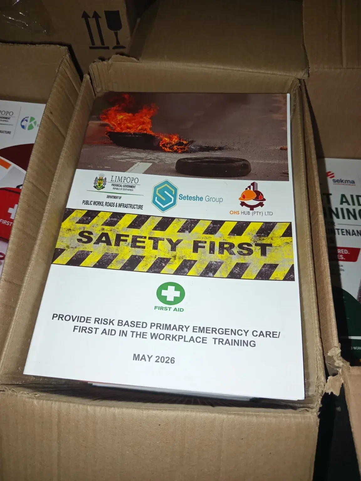 Printed workplace safety and first aid training manuals boxed for delivery