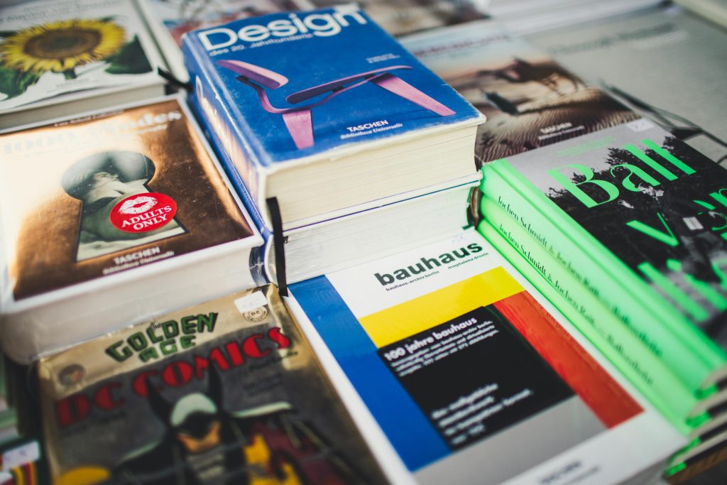 Book Printing Johannesburg A colorful array of books on design and literature, perfect for art lovers and comic enthusiasts.